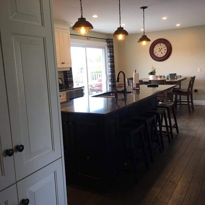 Kitchen dining area with pendant lighting and wall clock